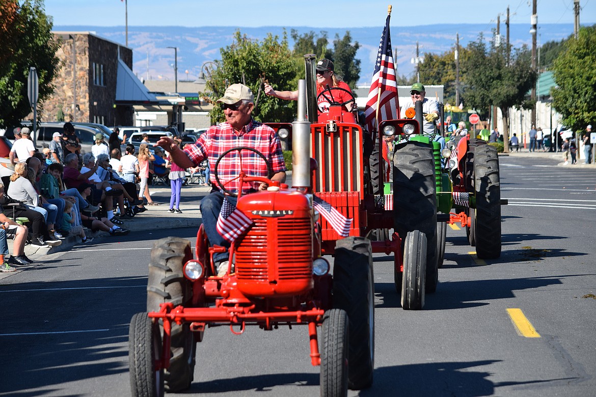 Antique tractors lead the way down the parade route during the 2021 Farmer Consumer Awareness Day parade.