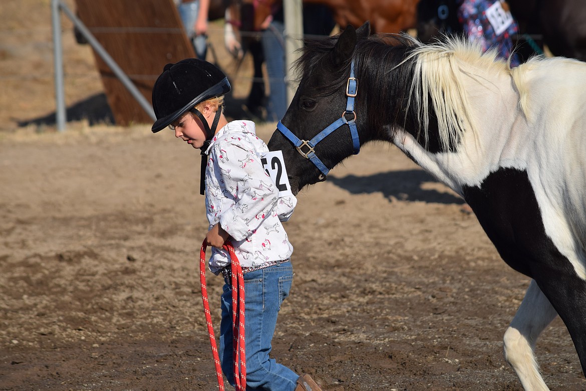 Hanna Giesen, 8, leads her pony, Mr. Beans, around the ring during fitting and showing horsemanship at the Wheat Land Communities’ Fair in Ritzville on Friday.