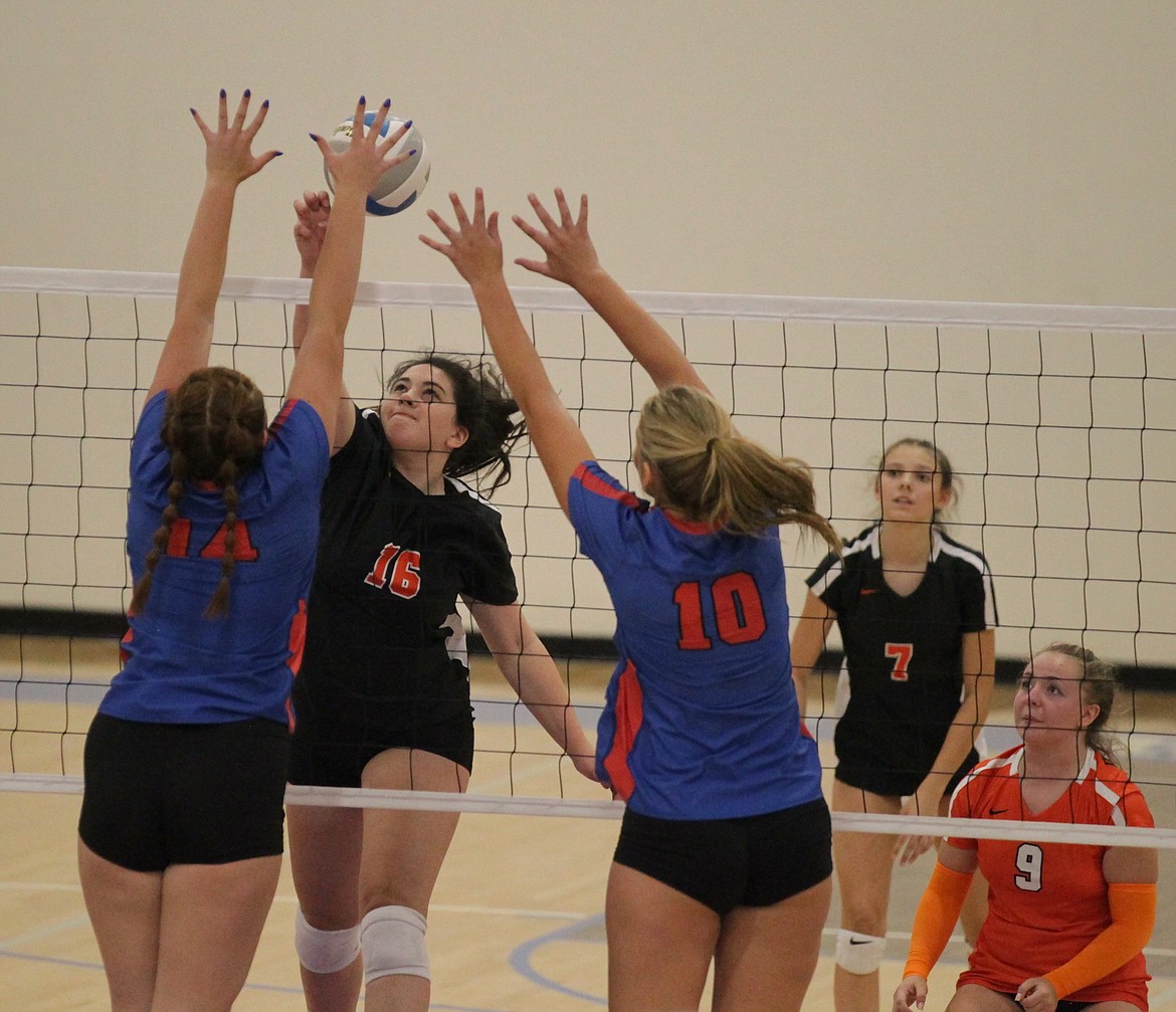 MARK NELKE/Press
Kaela Gump (16) of Post Falls jousts at the net as Gia Janke (14) and Lindsay Stubbs (10) of Coeur d'Alene put up a block Tuesday night at Viking Court.