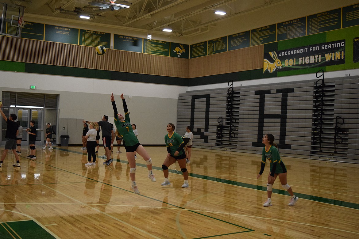 A setter places the ball during Quincy High School volleyball practice Friday.