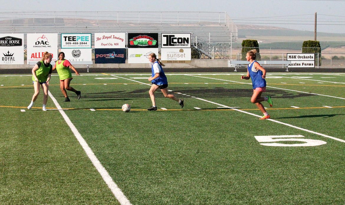 Royal High School girls soccer players kick the ball around Thursday at practice. Their defense is looking strong this year, several players said.