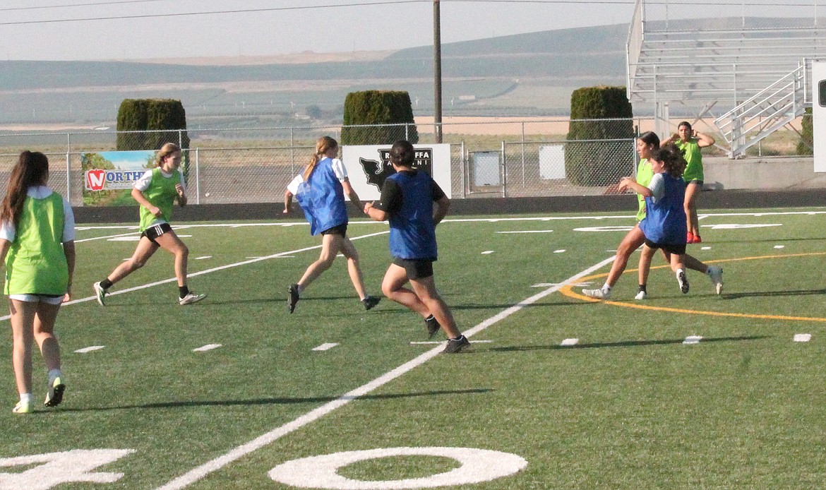 Royal Knights soccer players dive into play at practice Thursday. A major focus this year will be on scoring goals, said Head Coach Jens Jensen.