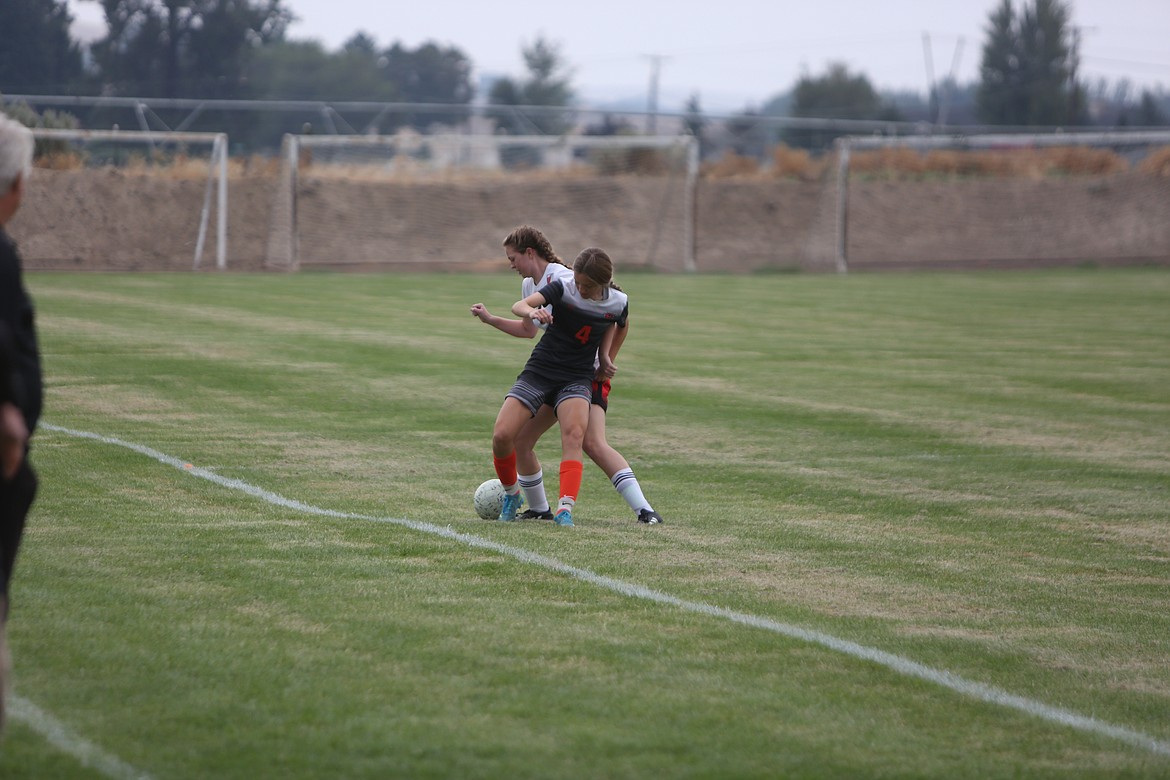 Junior midfielder Kendall Laugen fights off a Cascade (Leavenworth) defender on Sept. 3, 2022.