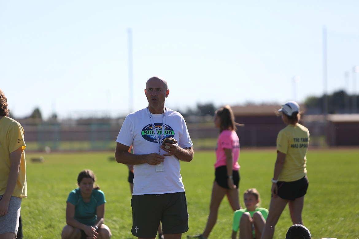 Moses Lake Cross Country head coach Larry Dagnon addresses the team after a practice on Sept. 5, 2022.