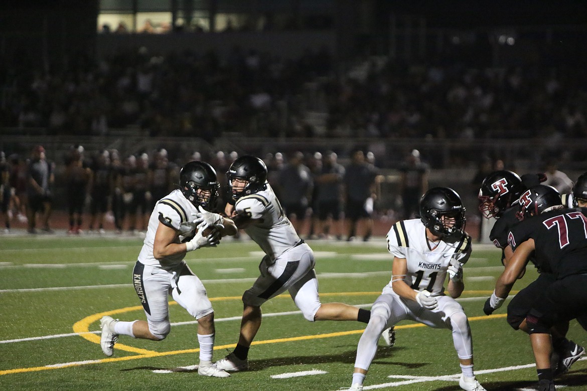 Royal’s Kaleb Hernandez, left, takes a handoff from quarterback Dylan Allred ,center, while receiver Lance Allred, right, makes a block in the Knight’s 34-6 win over Toppenish. Royal travels to Othello to face the Huskies on Friday.