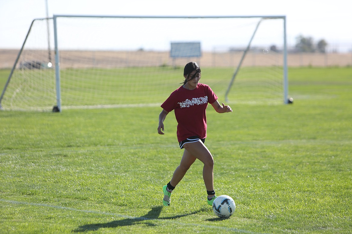 Warden senior Lisbet Martinez looks to pass the ball on to a teammate during a drill in practice.