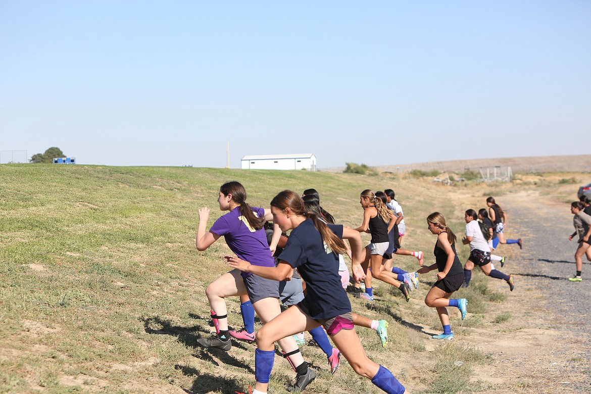 The Cougars began practice with conditioning drills, running up and down a hill next to the practice field.