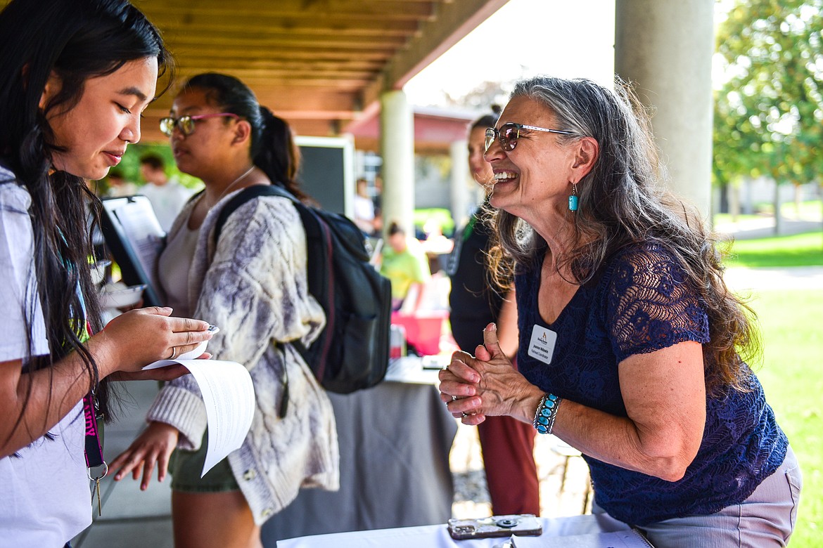 Jeanne Wdowin, right, Flathead County coordinator with Writing Coaches of Montana, talks with a student at Flathead Valley Community College's Involvement Fair on Wednesday, Sept. 7. (Casey Kreider/Daily Inter Lake)