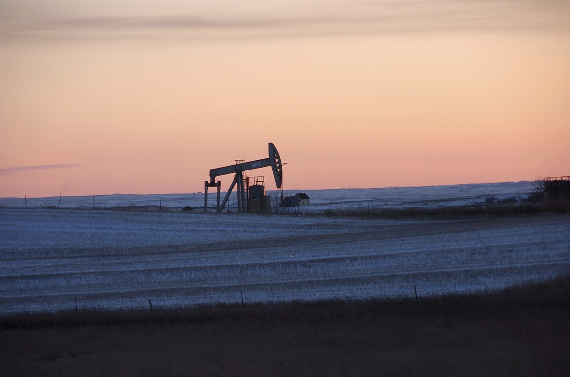 In this Feb. 25, 2015 photo, a pump jack for pulling oil from the ground is seen near New Town, N.D.