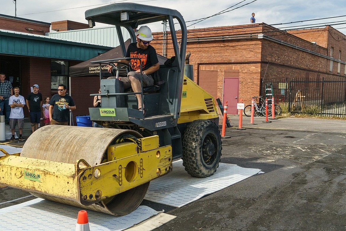 Jeremy Jenkins drives the asphalt roller to make prints during the 2019 INK! Print Rally. This year's rally is Saturday from 1-7 p.m. at and around Emerge, 119 N. Second St., Coeur d'Alene.