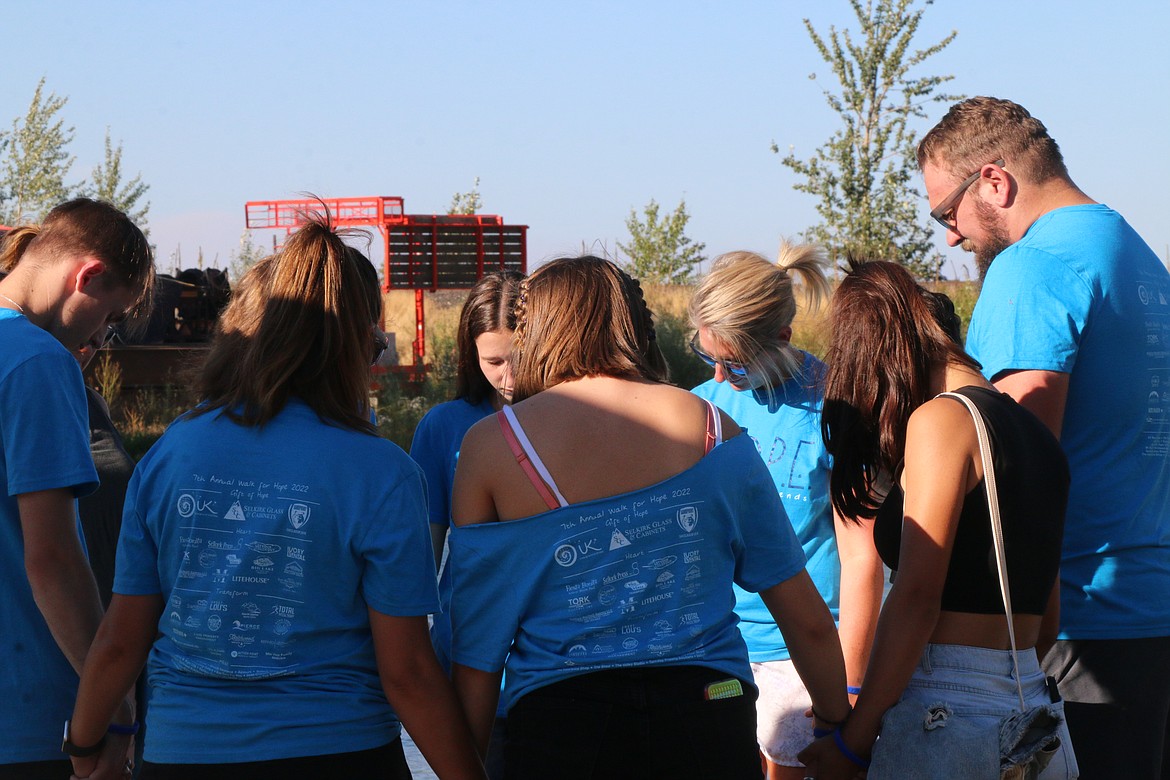 A few participants pray before the start of Sunday's Walk for HOPE.