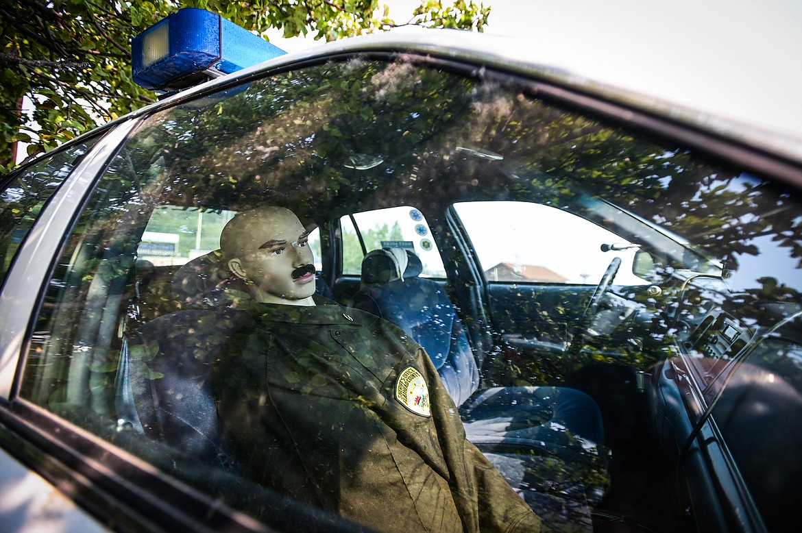Omar sits in the passenger seat of the decoy police vehicle "Lucky" in Lakeside on Thursday, Sept. 8. The 1995 Ford Crown Victoria is being retired. (Casey Kreider/Daily Inter Lake)