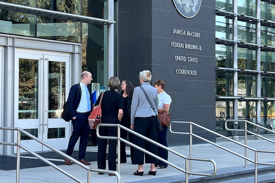 U.S. Department of Justice attorney Brian Netter, left, and Boise attorney Wendy Olson, center, talk with Idaho Sen. Melissa Wintrow, right, Boise Unitarian Universalist Fellowship Rev. Sara LaWall, second from left, and Collister United Methodist Rev. Jenny Willison Hirst, second from right, after oral arguments in the federal courthouse in Boise, Idaho, on Aug. 22, 2022. The Idaho Legislature has asked a federal judge to reconsider his decision blocking the state from enforcing a strict abortion ban in medical emergencies. (AP Photo/Rebecca Boone, File)