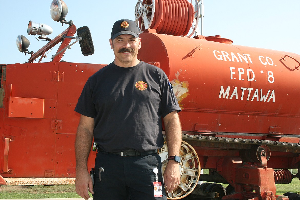 Matt Hyndman with the first fire rig owned by Grant County Fire District 8, now outside the station on Road 22.5 NW. The department was founded in June of 1958 and has served the community around Mattawa since that time.