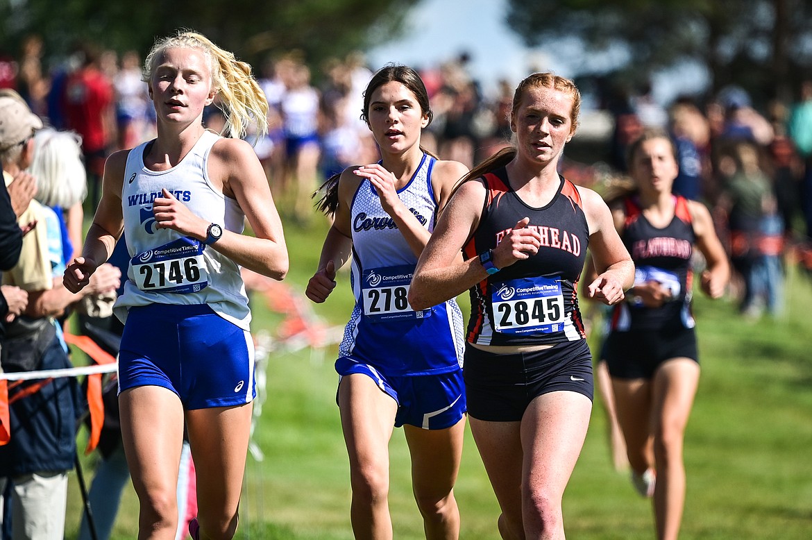 Columbia Falls' Siri Erickson, Corvallis' Laurie Davidson and Flathead's Madelaine Jellison complete the first lap of the Flathead Invite at Rebecca Farm on Friday, Sept. 9. (Casey Kreider/Daily Inter Lake)