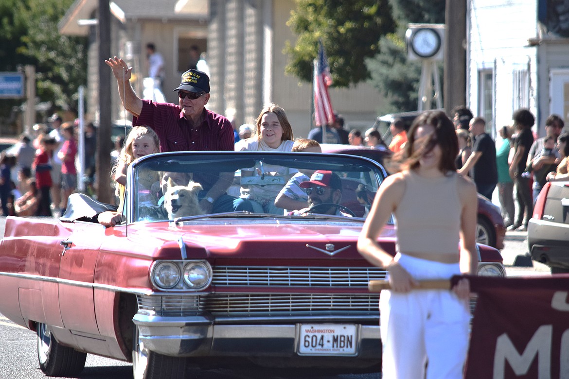 Warden Community Days Grand Marshall Gary Olson waves to the crowd from his 1964 Cadillac convertible during the Warden Community Days Parade on Sept. 5.