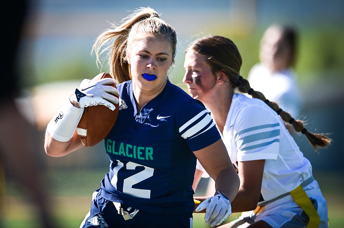 Glacier's Aubrey Price (12) is tackled by Flathead's Alexis Kersten (27) at Legends Stadium on Saturday, Sept. 10. (Casey Kreider/Daily Inter Lake)