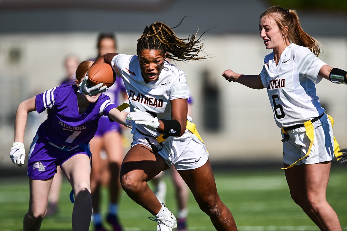 Flathead receiver Akilah Kubi (12) picks up yardage after a reception with the help of teammate Harlie Roth (6) against Butte at Legends Stadium on Saturday, Sept. 10. (Casey Kreider/Daily Inter Lake)