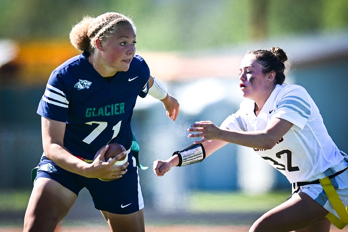 Glacier quarterback Kia Johnson (71) avoids a tackle by Flathead's Autumn Thompson (32) at Legends Stadium on Saturday, Sept. 10. (Casey Kreider/Daily Inter Lake)