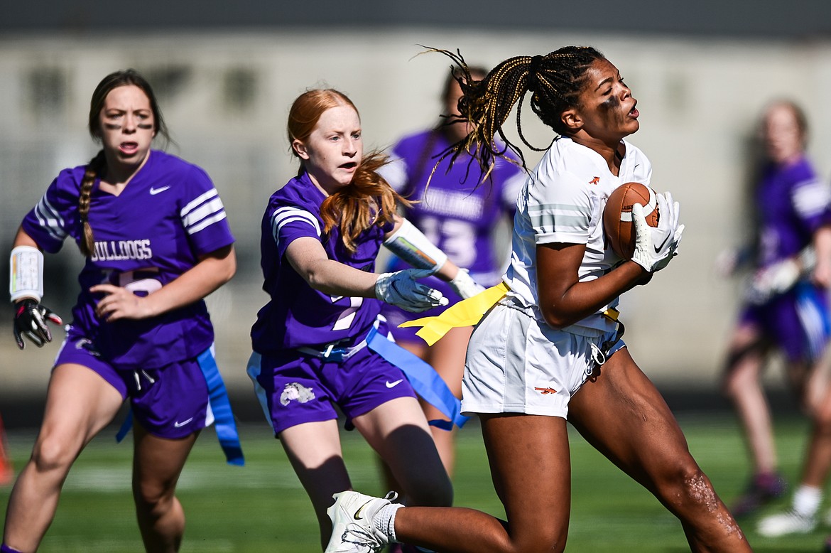 Flathead receiver Akilah Kubi (12) tips a pass into the air and makes the reception against Butte at Legends Stadium on Saturday, Sept. 10. (Casey Kreider/Daily Inter Lake)