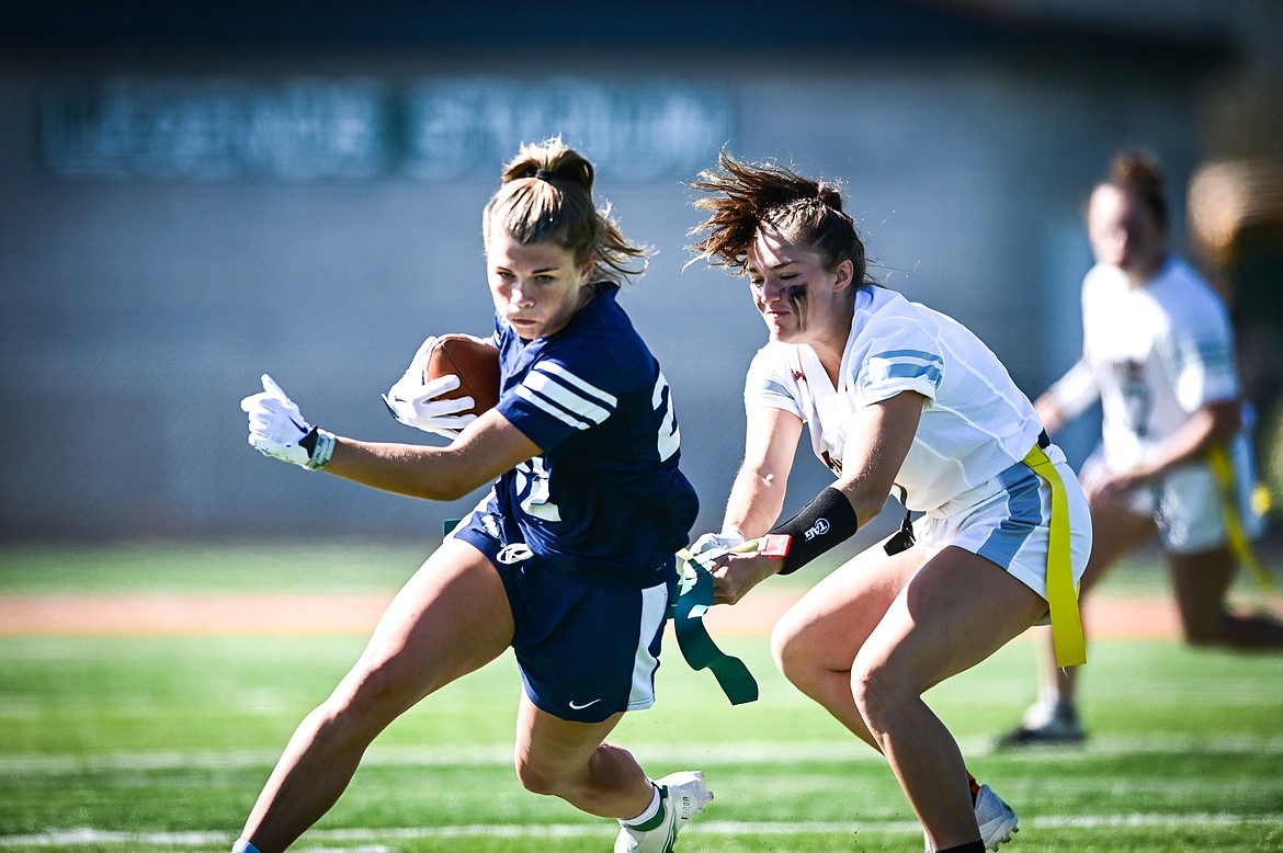 Glacier's Noah Fincher (22) is tackled by Flathead's Audree Kushner (7) at Legends Stadium on Saturday, Sept. 10. (Casey Kreider/Daily Inter Lake)