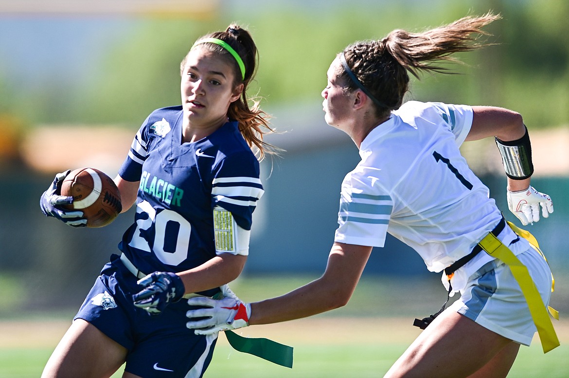 Glacier's Karley Allen (20) is tackled by Flathead's Peyton Walker (1) at Legends Stadium on Saturday, Sept. 10. (Casey Kreider/Daily Inter Lake)