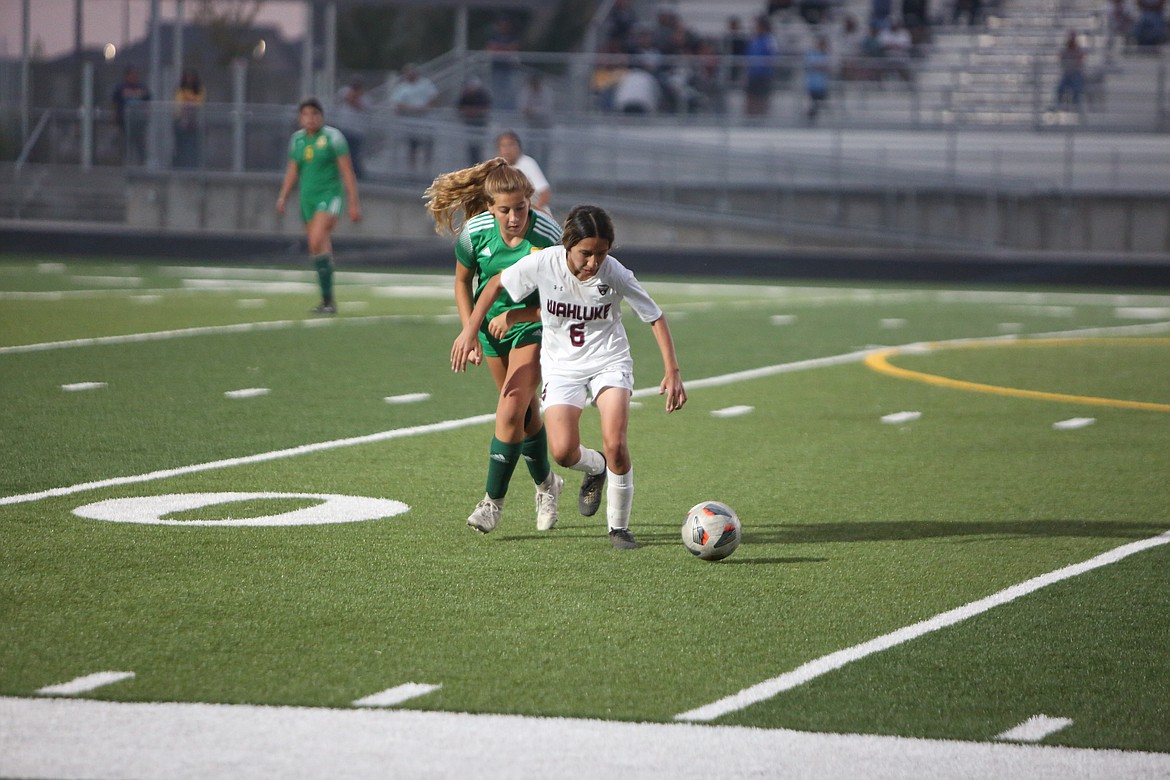 Wahluke’s Carmen Barbosa (6) fights off a Quincy defender during the Warriors’ 1-0 win over the Jacks on Thursday night.