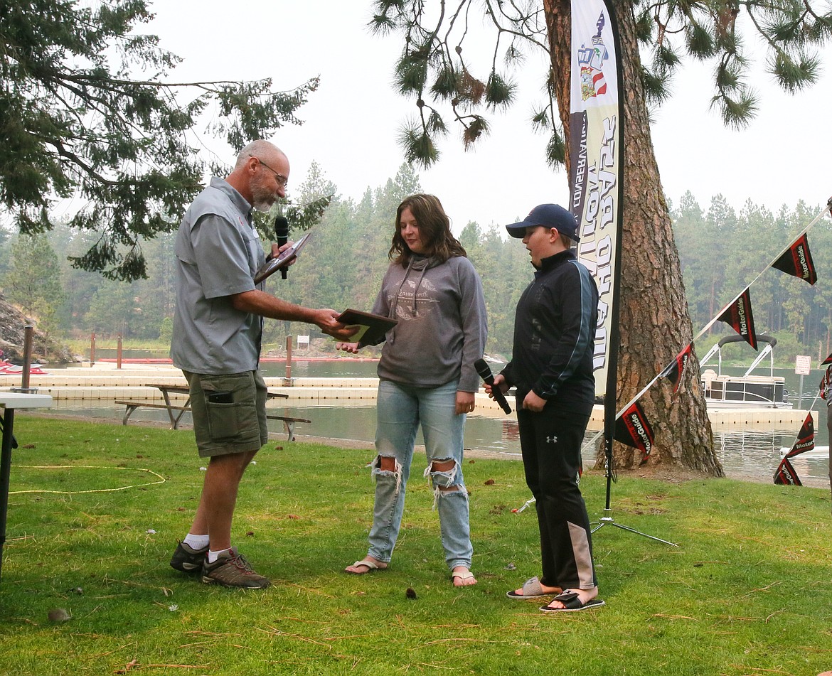 C.A.S.T. for Kids event coordinator Chris Rambough awards plaques to Post Falls siblings Faith Banks, 14, and Christian Banks, 12, after a Sunday morning of fishing.
