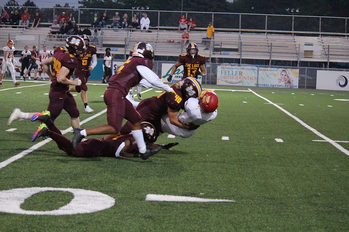 The Moses Lake defense led by Noah Burns (40) stuffs the Kamiakin runner.