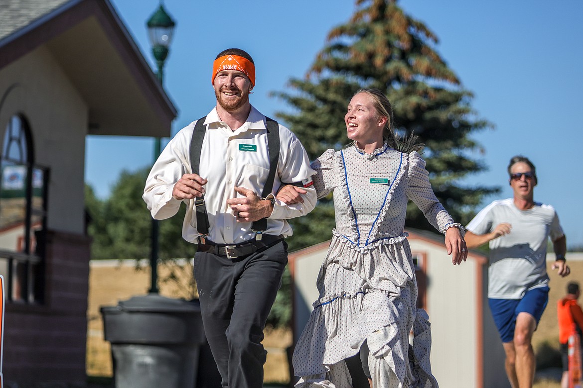 Garrett and Kayla Tenney compete with their Conrad Mansion uniforms in the Great Fish Fun Run competitive race on Saturday at Depot Park. (JP Edge photo)