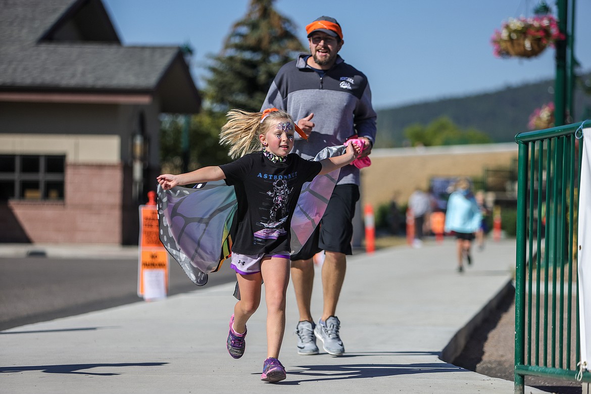 Baun and Charlotte Ellsworth fly to the finish at the Great Fish Fun Run on Saturday at Depot Park. (JP Edge photo)