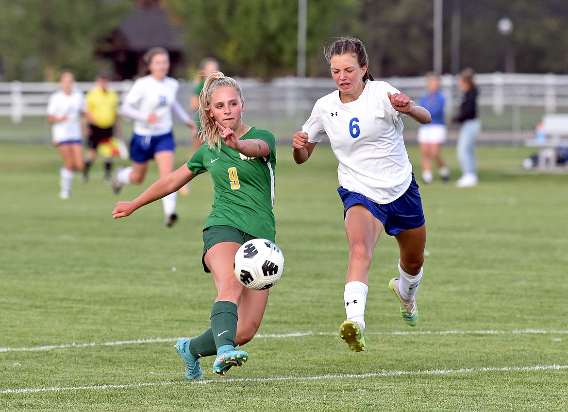 Whitefish forward Delaney Smith gets around a Libby defender for a shot on goal during a game at Smith Fields on Thursday. (Whitney England/Whitefish Pilot)