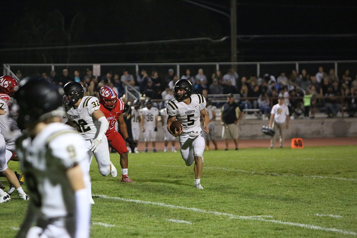 Royal quarterback Dylan Allred (5) takes the ball upfield on a quarterback run.