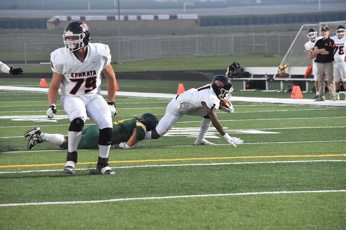 Ephrata running back Tyler Raine (1) powers through a Quincy defender.