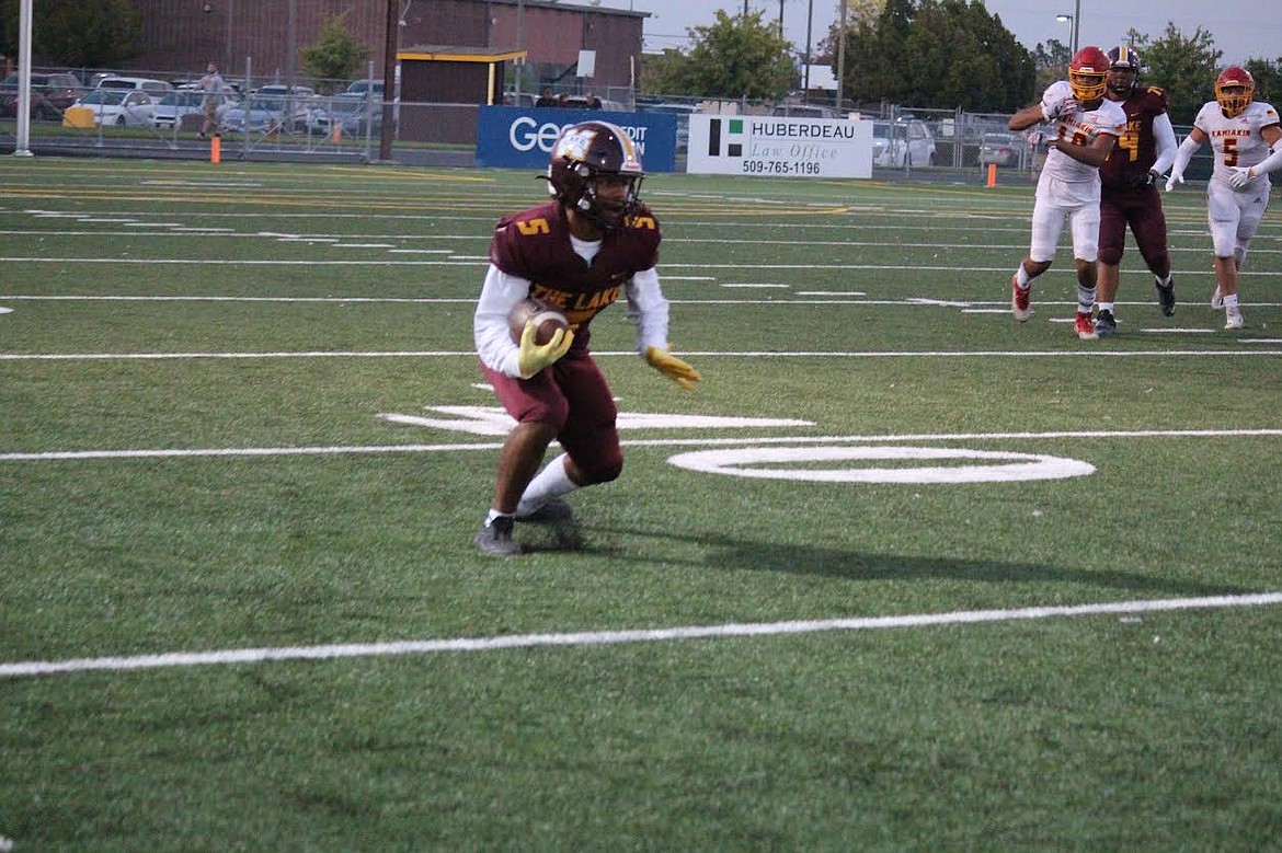 Moses Lake's Kyson Thomas (5) pivots during a punt return in Friday's game with Kamiakin.