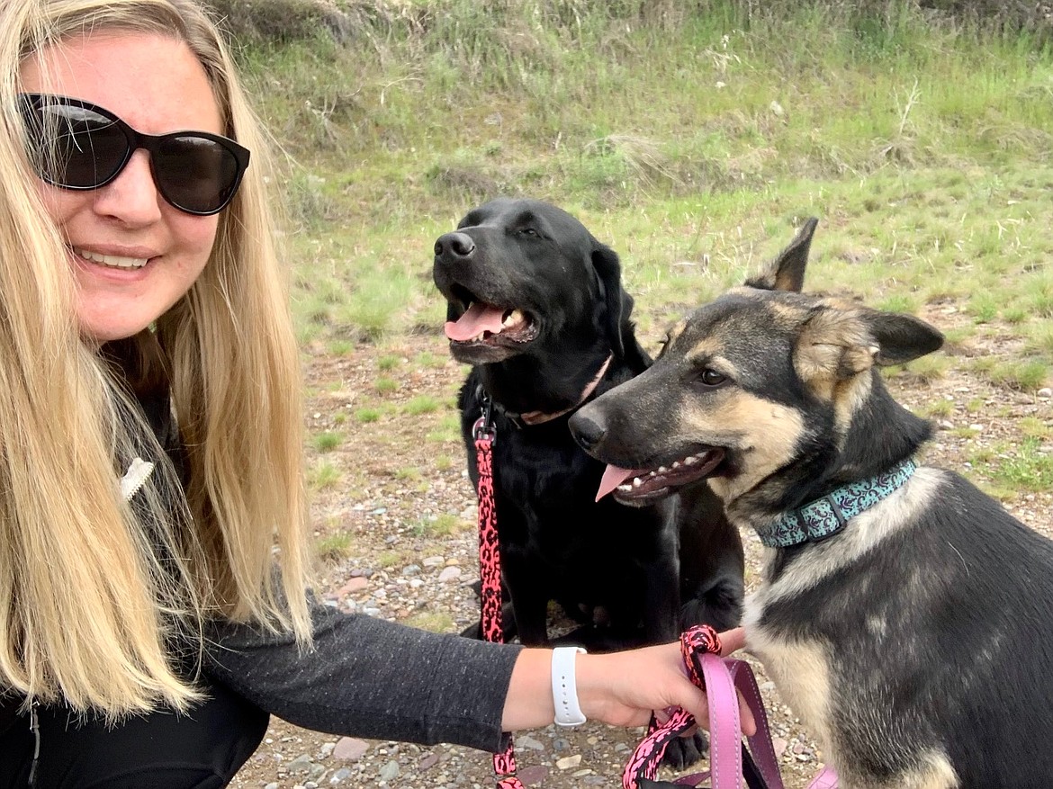 Bessie Spangler, of Superior, is out on a walk with her black lab Molly, and German Shepherd rescue pup Piper. Spangler, along with her three dogs and two cats, generously welcome lost dogs, strays and other animals in need of adoption from around the county into their home. (Photo courtesy/Bessie Spangler)