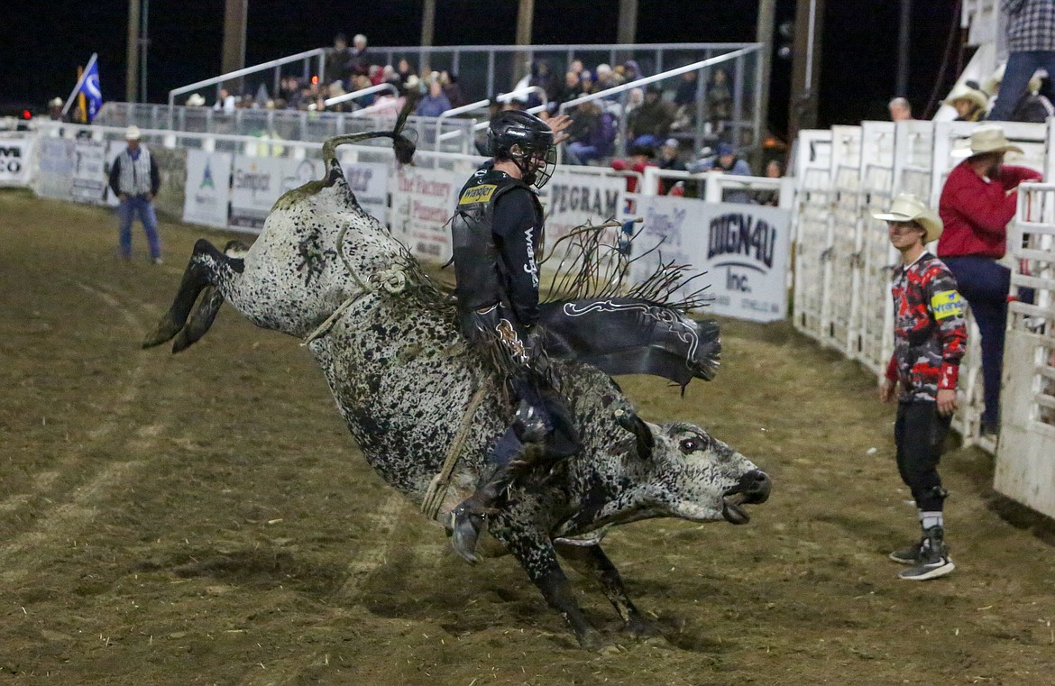 A bull rider tries to survive eight seconds at the 2021 Othello Rodeo. The 2022 rodeo, Othello Demolition Derby and Othello Fair start Wednesday and are expected to draw large crowds.