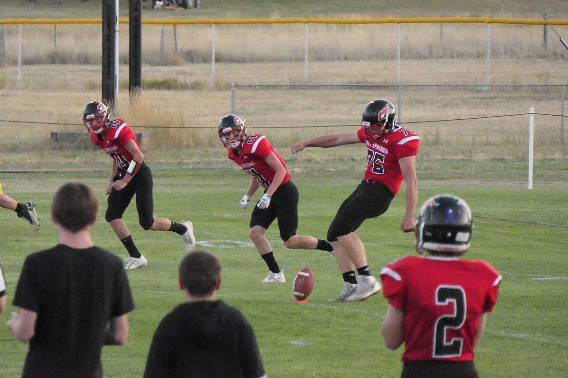 Hot Springs senior Garther Parker (75) boots the opening kickoff of Friday night's football game against Twin Bridges in Hot Springs. (Chuck Bandel/VP-MI)