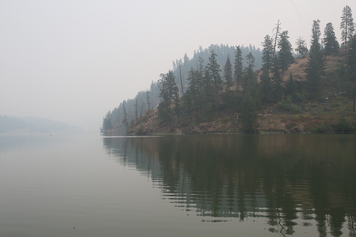 Mountains around Fernan Lake seem to disappear into nothing as wildfire smoke fills the region Monday. The Idaho Department of Environmental Quality has issued an "unhealthy" air advisory for North Idaho.