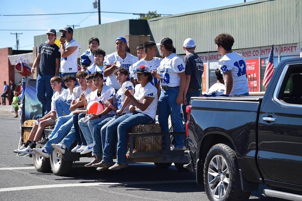 Members of the Warden High School football team celebrate Warden Community Days from the back of a parade float.