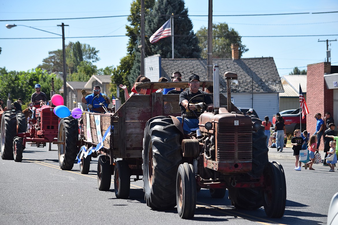 An antique tractor pulling an antique cart carrying members of the Warden Community Church during the Warden Community Days Parade on Sept. 5.