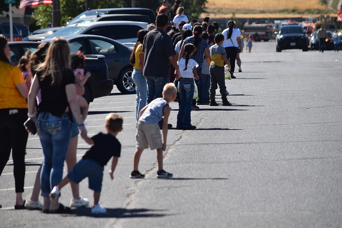 Children get ready to grab candy tossed by participants as the 2022 Warden Community Parade slowly begins to make its way up Main Avenue in downtown Warden on Sept. 5. The parade was the first Community Days parade held in Warden since 2019.