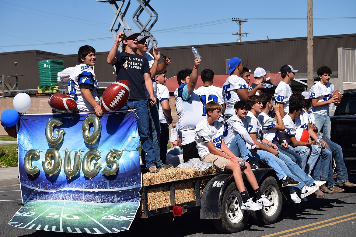 Members of the Warden High School football team celebrate Warden Community Days from the back of a parade float.