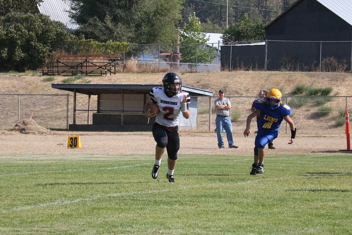 ACH quarterback Carter Pitts runs with the ball in the Warriors’ 40-0 win over Columbia