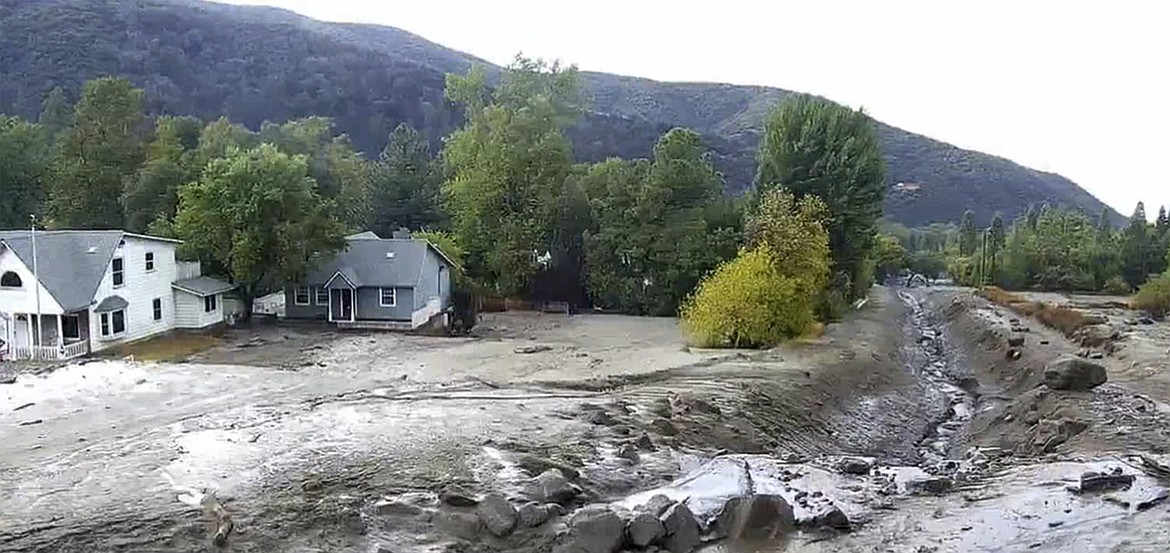 In this photo released by the San Bernardino County Fire Department mud flows near homes in Oak Glen, in San Bernardino County, Calif., on Monday, Sept. 12, 2022. (San Bernardino County Fire Department via AP)