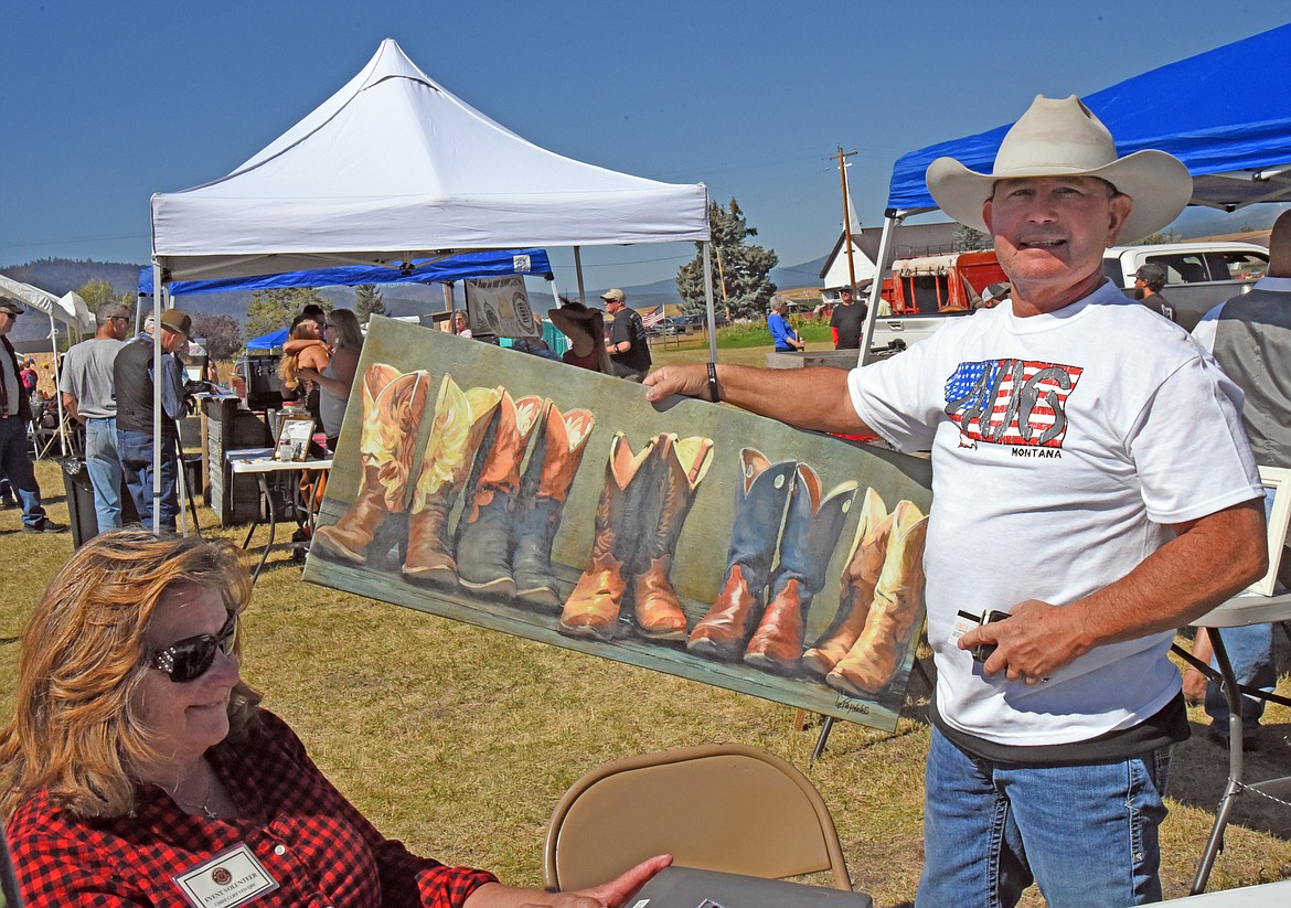 Eddy Fox shows the painting he bought as a "buy it now" item at the silent auction. (Marla Hall/Lake County Leader)