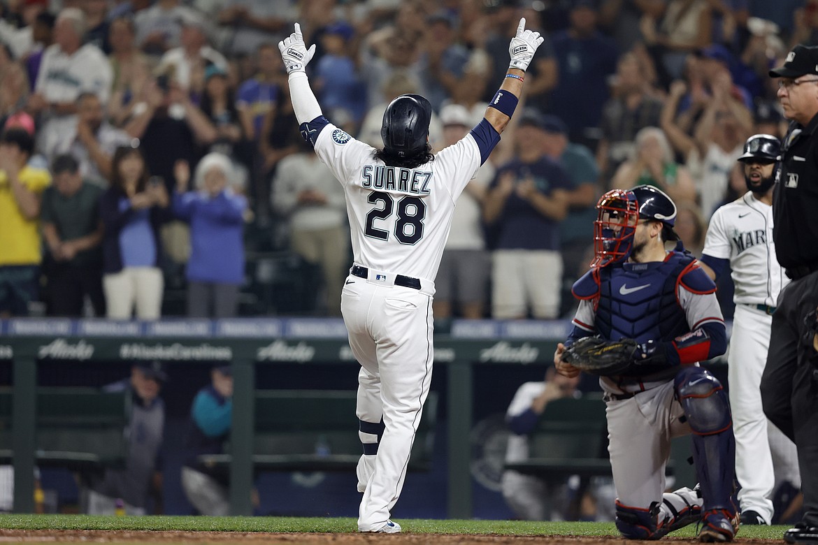 Seattle Mariners' Eugenio Suarez celebrates his solo home run on a pitch from Atlanta Braves starting pitcher Max Fried during the sixth inning of a baseball game, Saturday, Sept. 10, 2022, in Seattle.