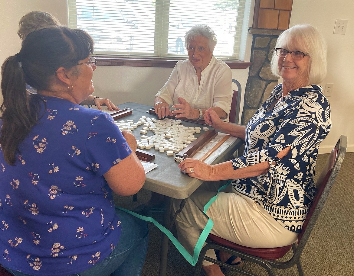 Kathy Lupien, left, June Davis, center, and Kristen Hiett enjoy socializing while playing a game at the Hayden Senior Center. The center is hosting a bingo event Saturday.