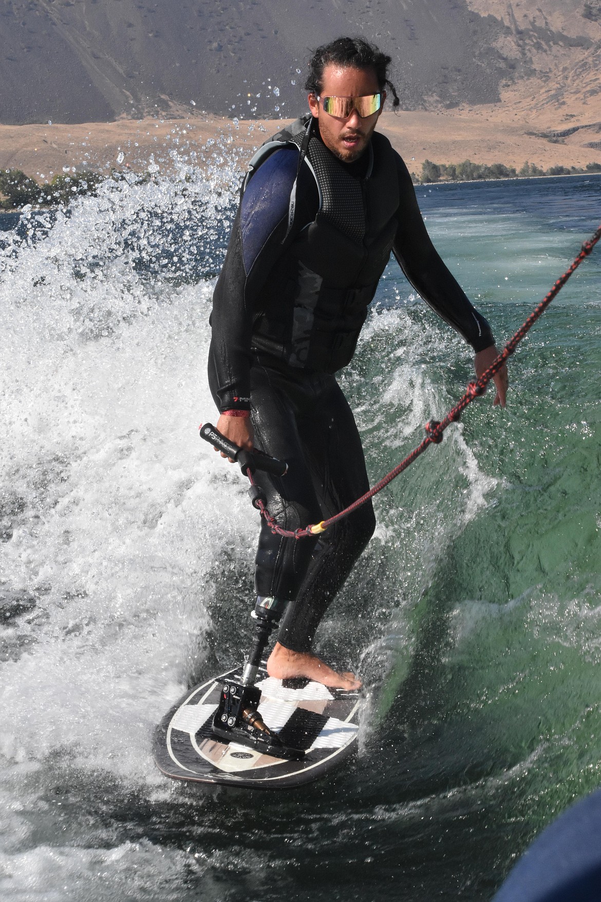 Anthony Farve surfs the Columbia River Saturday at the Crescent Bar Wake For Warriors event.