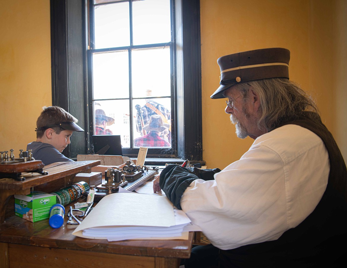 Lucas Baker is taught how to use a telegraph at Bannack State Park. (Tracy Scott/Valley Press)